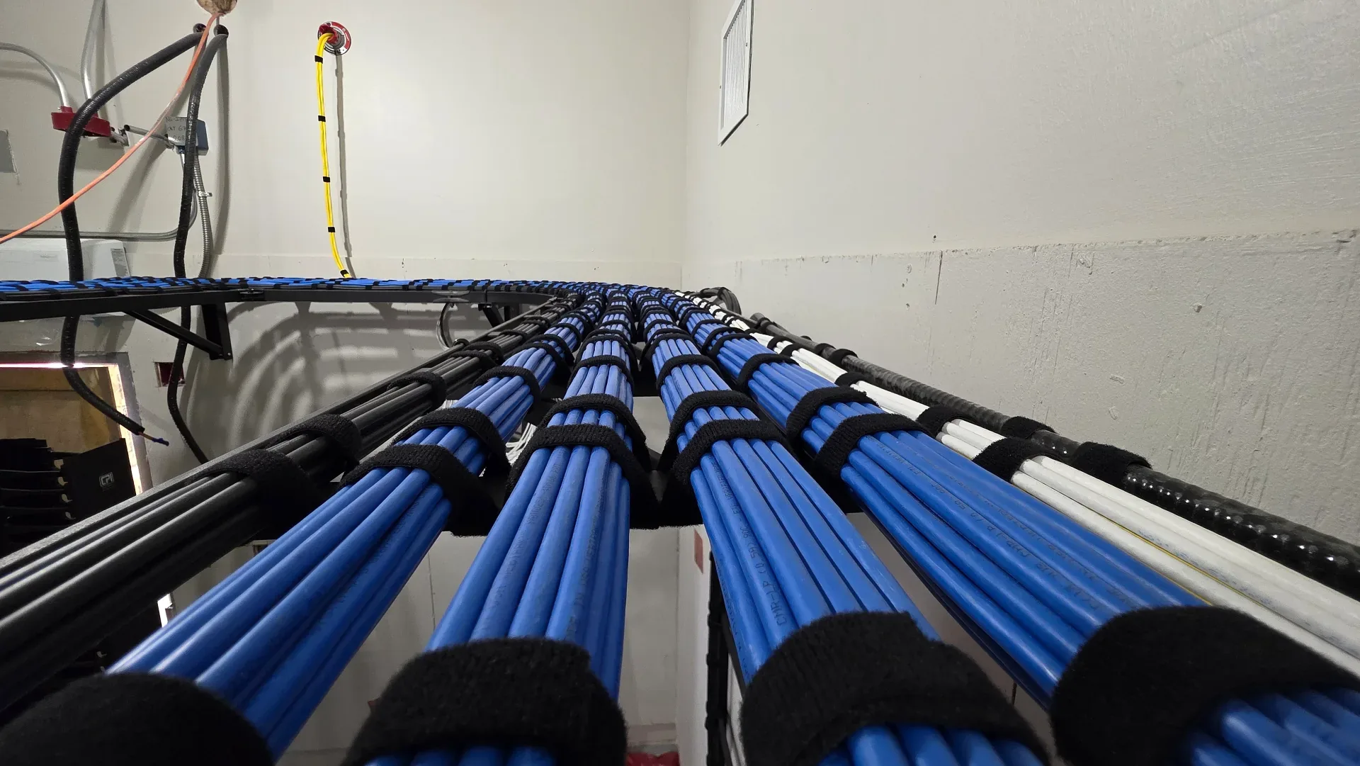 TSS USA technician installing structured cabling in a Tampa Bay commercial building